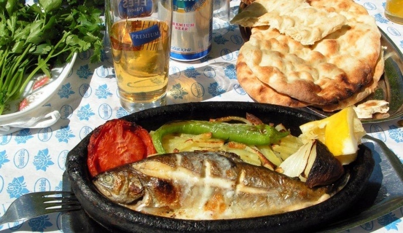 Ryba se zeleninou, pečivem a sklenicí piva
